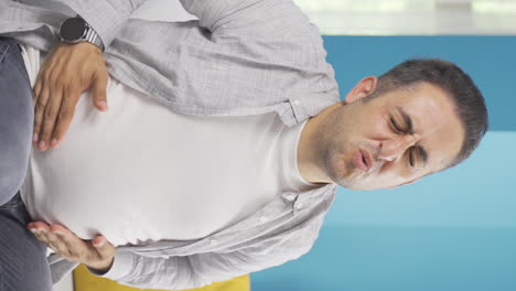 Vertical-video-of-Man-experiencing-stomachache.